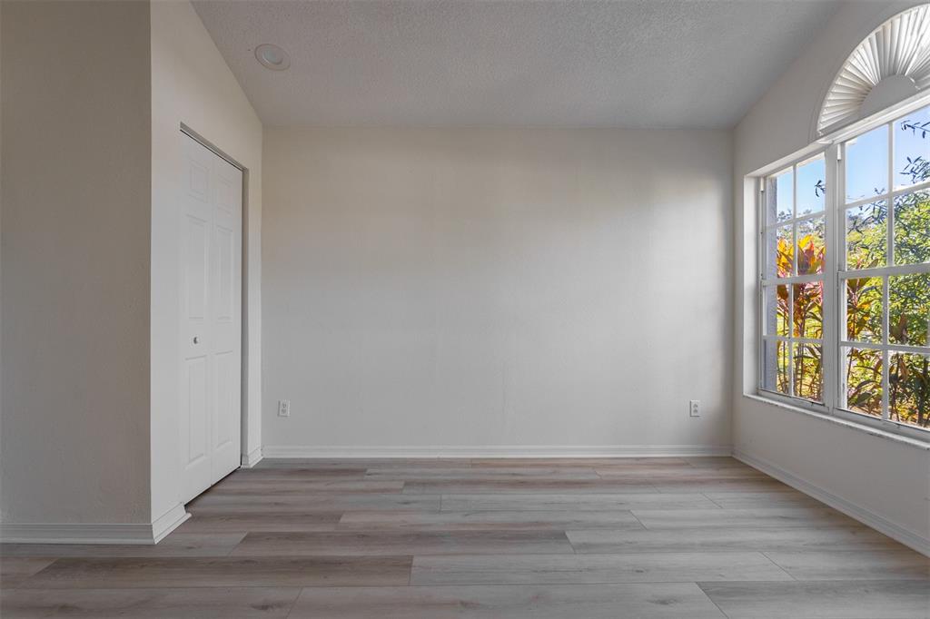 1734 Powder Ridge Drive Valrico, FL 33594 - Photo 24 of 32 a view of an empty room with wooden floor and a window