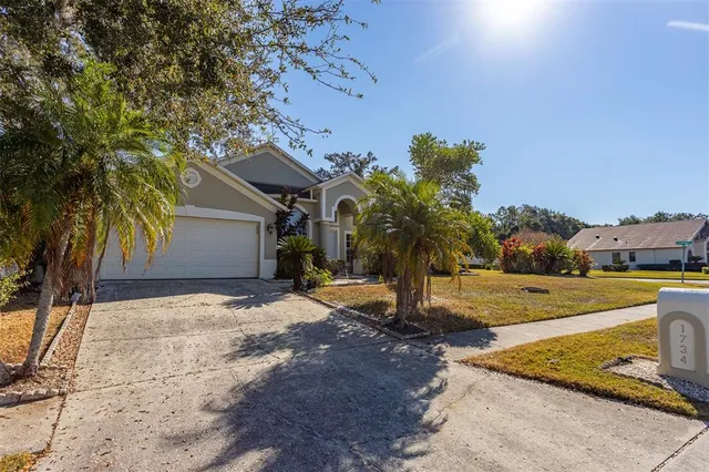 a view of a house with a yard and tree s