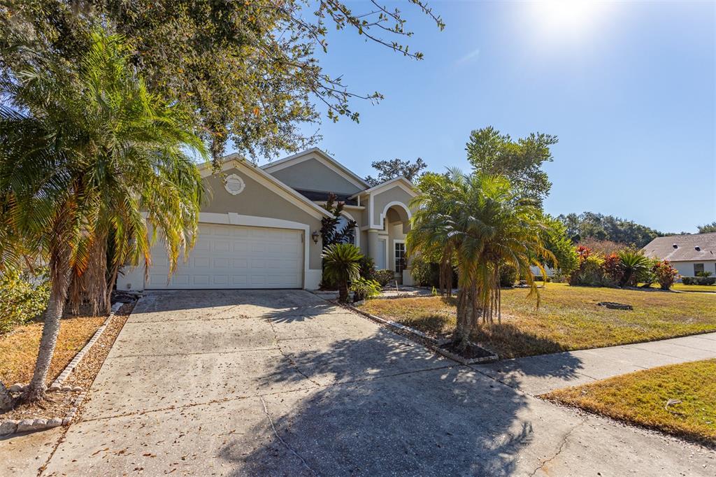 1734 Powder Ridge Drive Valrico, FL 33594 - Photo 30 of 32 a front view of a house with a yard and trees