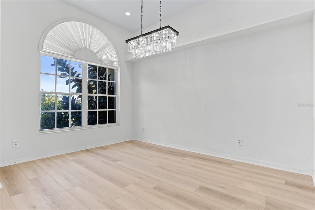 1734 Powder Ridge Drive Valrico, FL 33594 - Photo 4 of 32 an empty room with wooden floor and windows