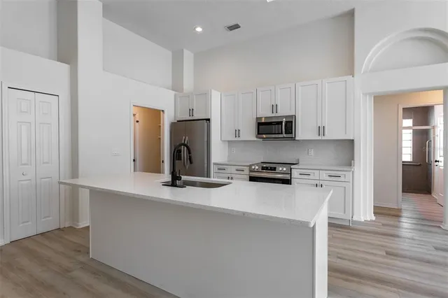 a kitchen with refrigerator a stove top oven a sink and dishwasher