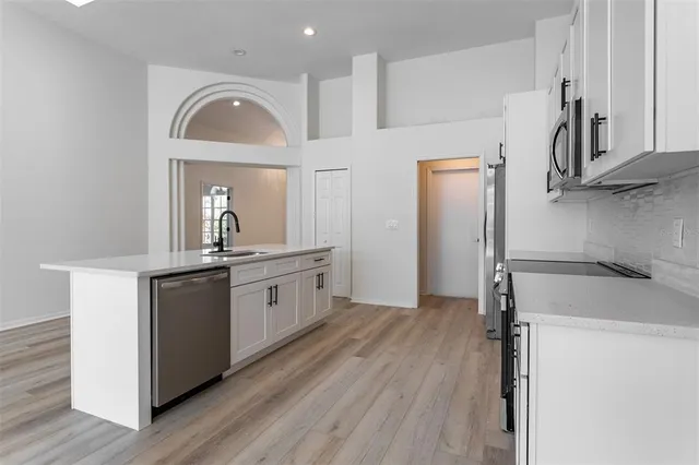 a kitchen with stainless steel appliances a refrigerator and a stove