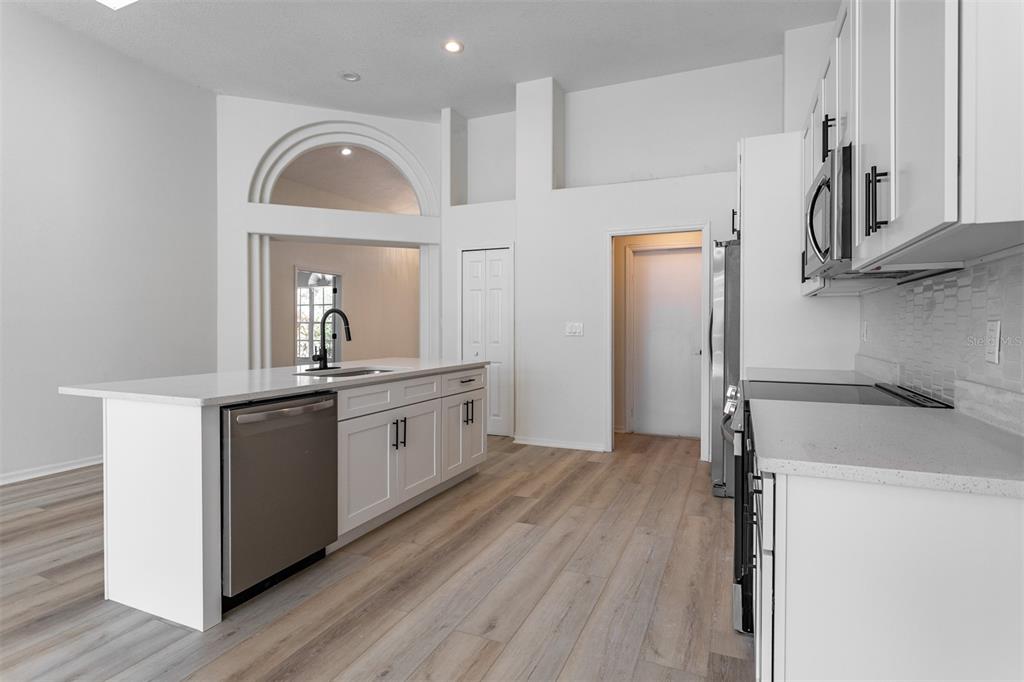 1734 Powder Ridge Drive Valrico, FL 33594 - Photo 7 of 32 a kitchen with stainless steel appliances a refrigerator and a stove