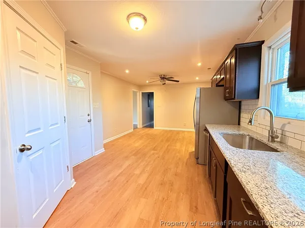 a spacious bathroom with a granite countertop sink a mirror and shower