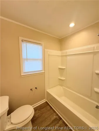 a bathroom with a toilet and shower