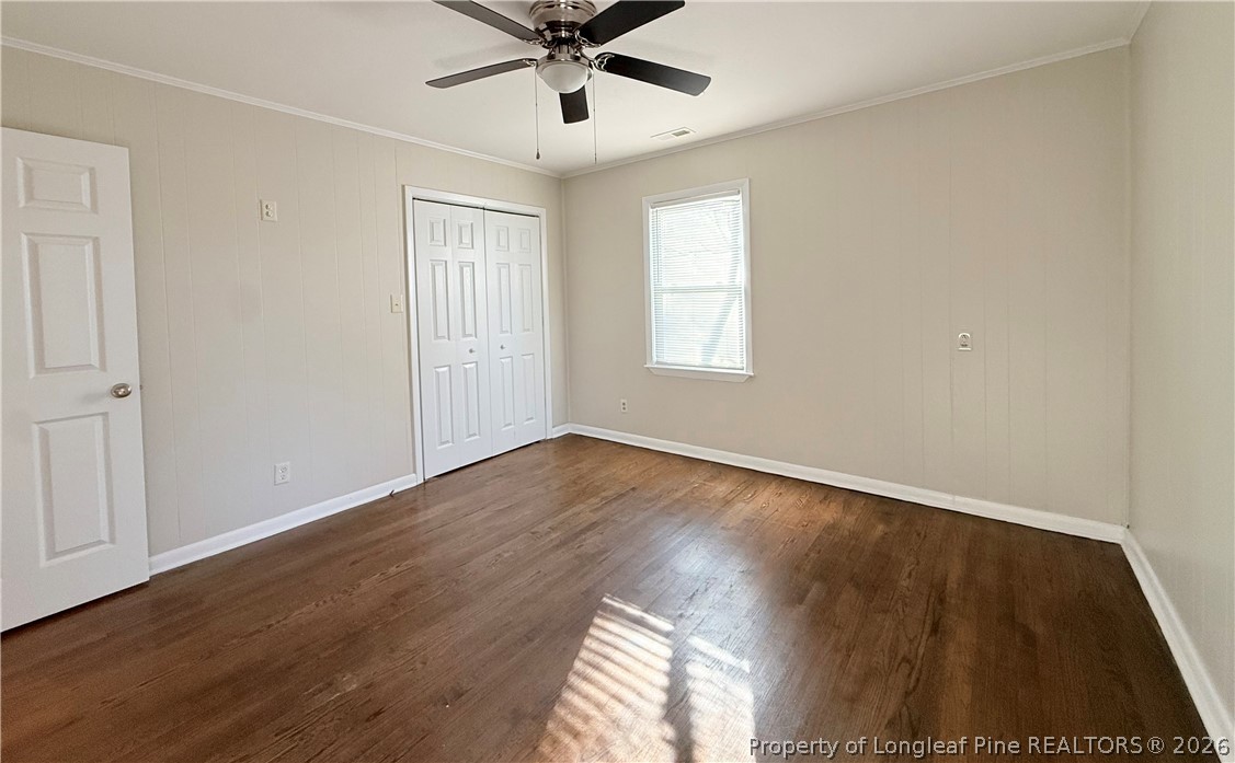 425 North Platte Road Fayetteville, NC 28303 - Photo 18 of 30 an empty room with wooden floor ceiling fan and windows