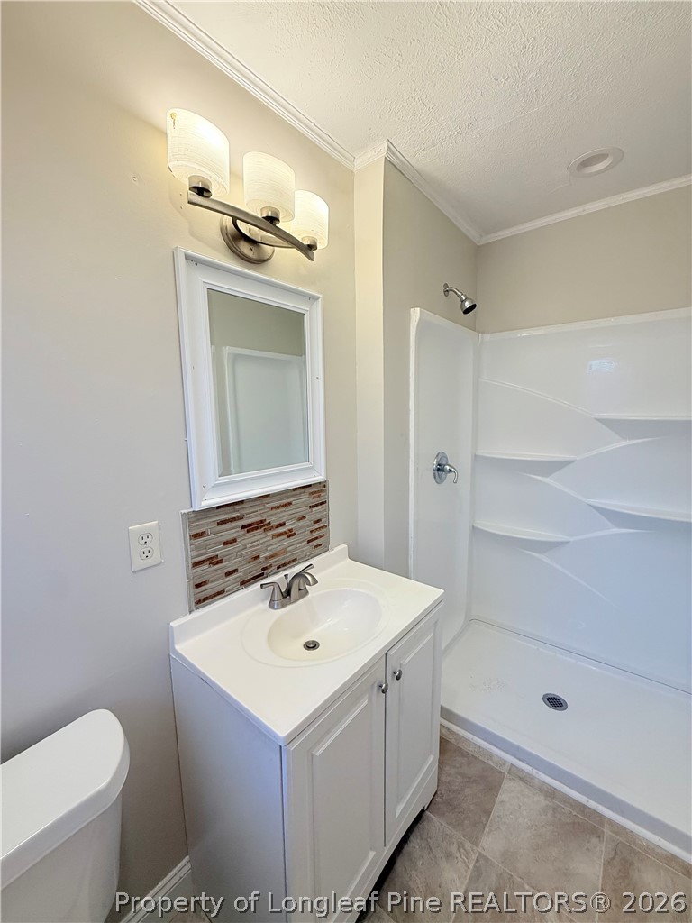 425 North Platte Road Fayetteville, NC 28303 - Photo 21 of 30 a bathroom with a sink a toilet and shower