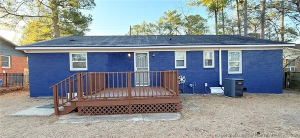 a view of a house with a wooden fence