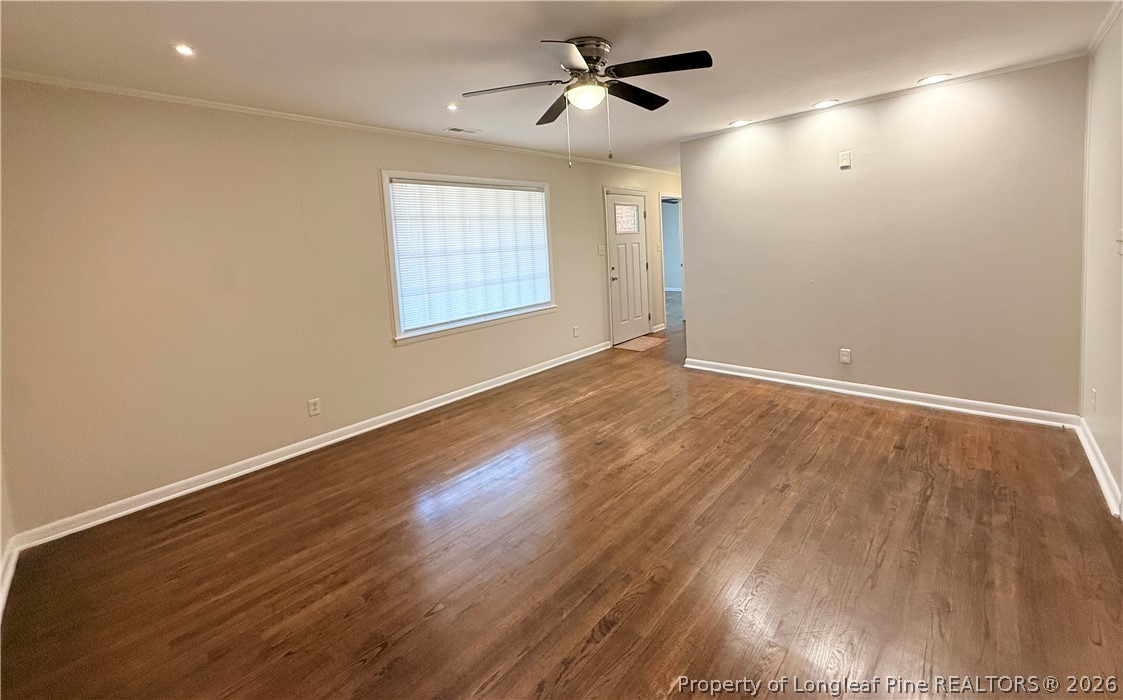 425 North Platte Road Fayetteville, NC 28303 - Photo 6 of 30 an empty room with wooden floor ceiling fan and windows