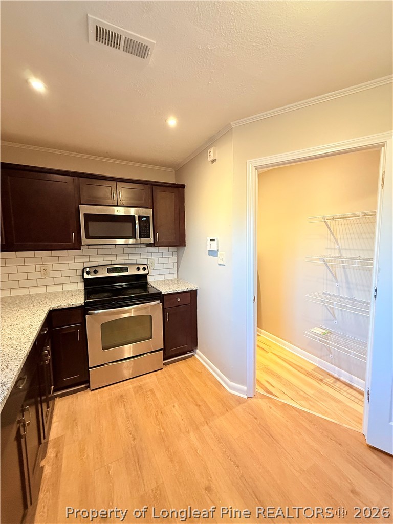 425 North Platte Road Fayetteville, NC 28303 - Photo 10 of 30 a kitchen with stainless steel appliances a stove a refrigerator and a sink