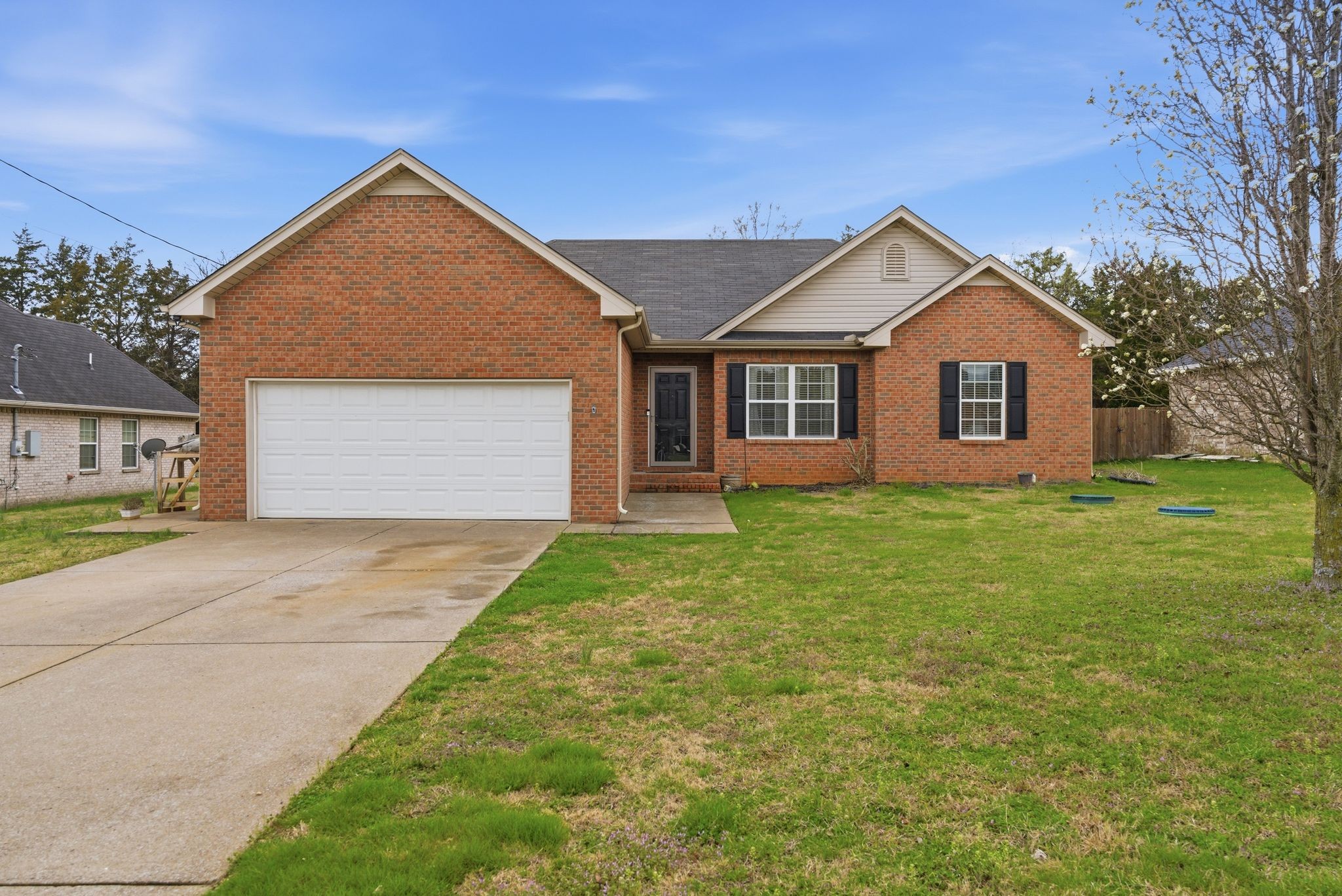 a front view of house with yard and green space