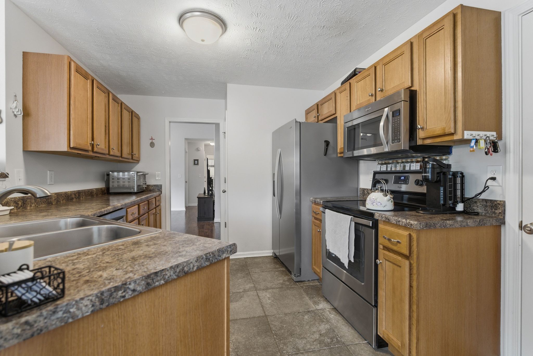 2045 Barretts Ridge Drive Murfreesboro, TN 37130 - Photo 12 of 33 a kitchen with stainless steel appliances granite countertop a stove a sink and a refrigerator