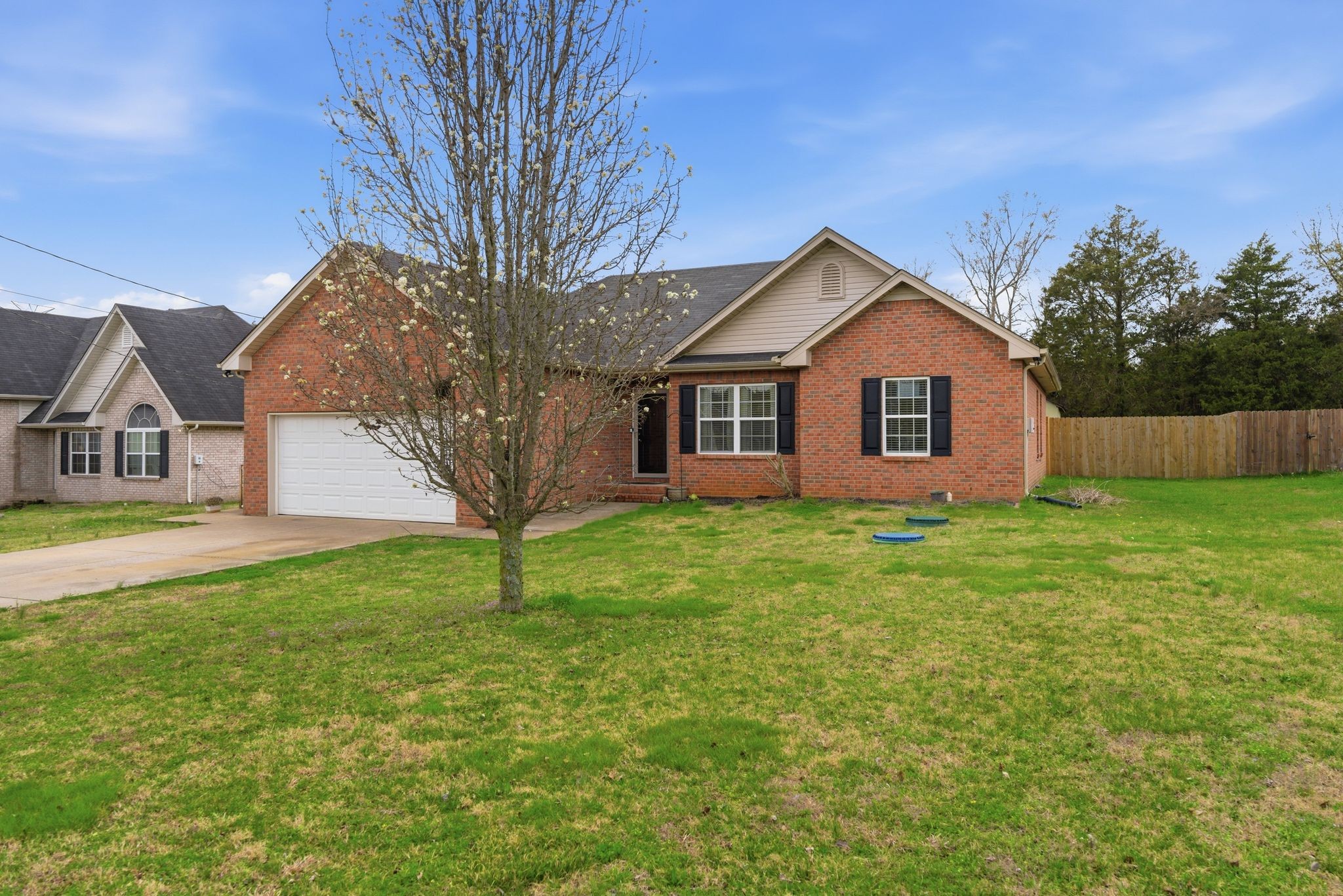 2045 Barretts Ridge Drive Murfreesboro, TN 37130 - Photo 33 of 33 a house that is sitting in the grass with large trees and sky view