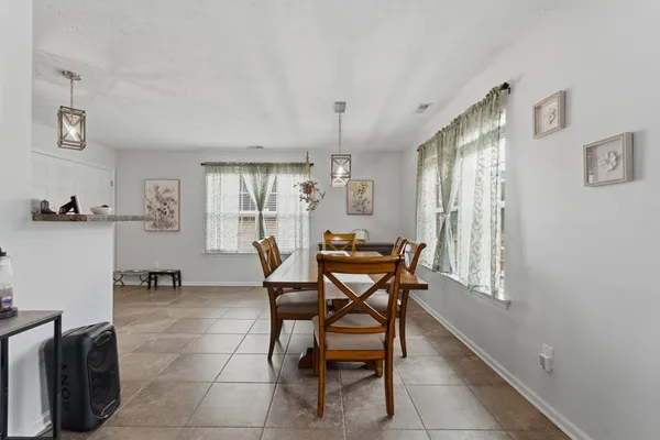 a view of a dining room with furniture and a window