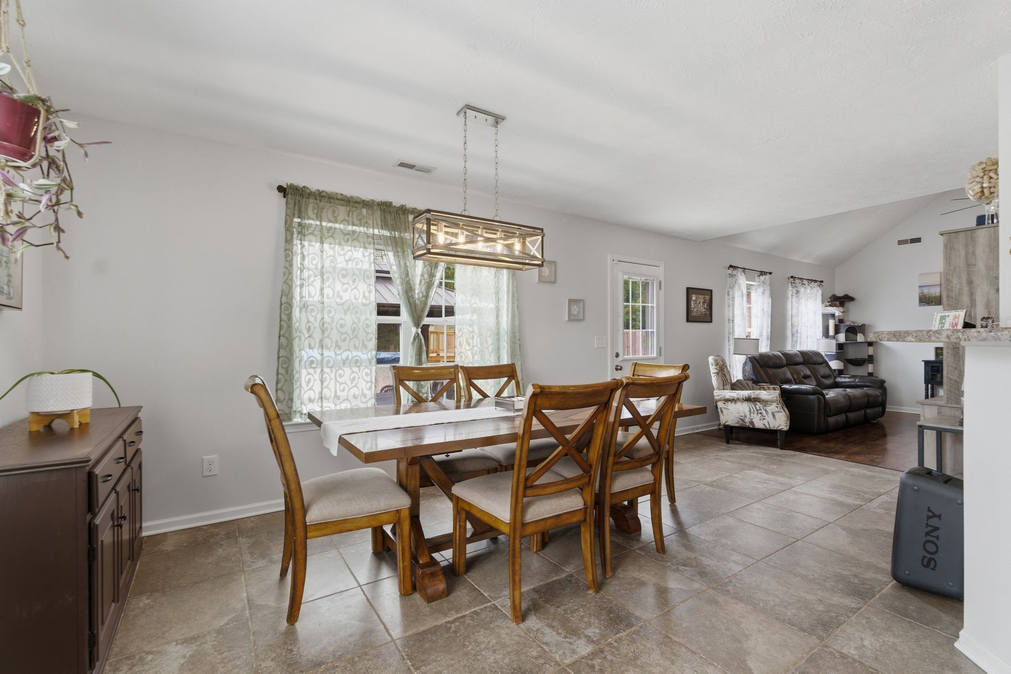 2045 Barretts Ridge Drive Murfreesboro, TN 37130 - Photo 9 of 33 a view of a dining room and livingroom with furniture wooden floor a rug a flat screen tv and a painting