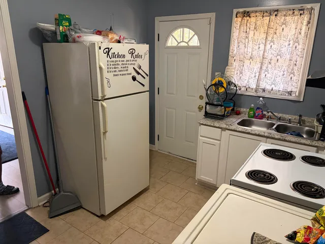 a white refrigerator freezer sitting inside of a kitchen