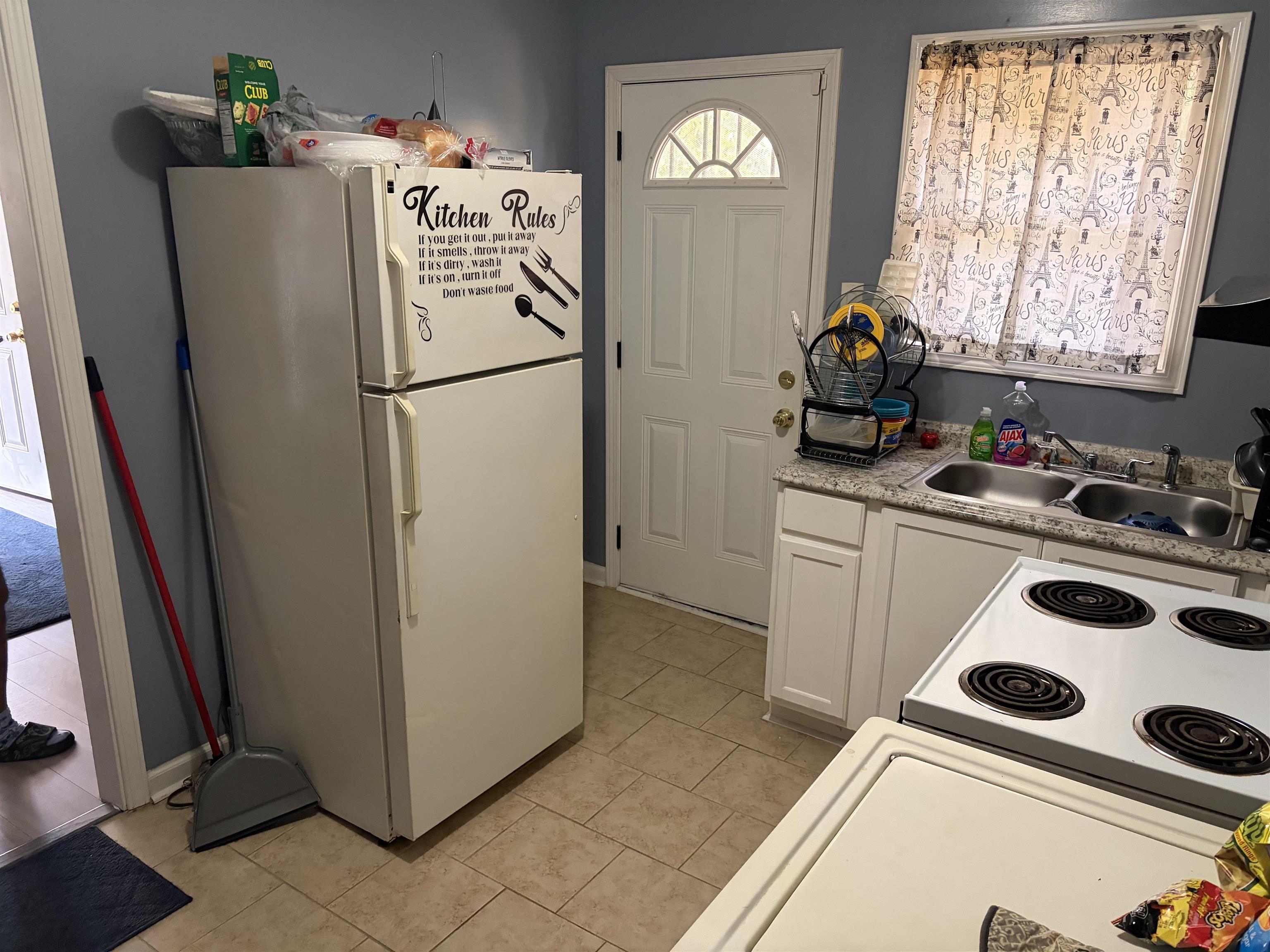 1278 Edith Avenue Memphis, TN 38106 - Photo 13 of 17 a white refrigerator freezer sitting inside of a kitchen