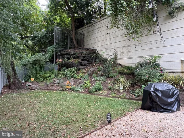 a view of backyard with outdoor seating and green space