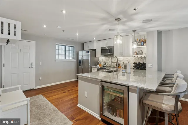 a kitchen with kitchen island a sink stove and chairs