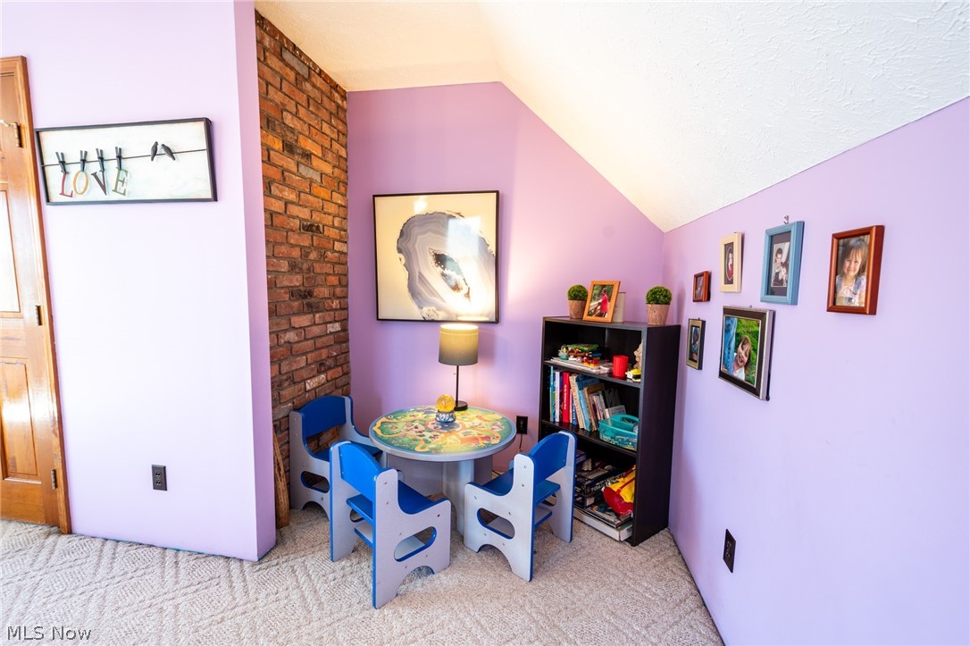 14027 Mayfield Road Huntsburg, OH 44046 - Photo 27 of 50 Room featuring a prominent exposed brick accent wall