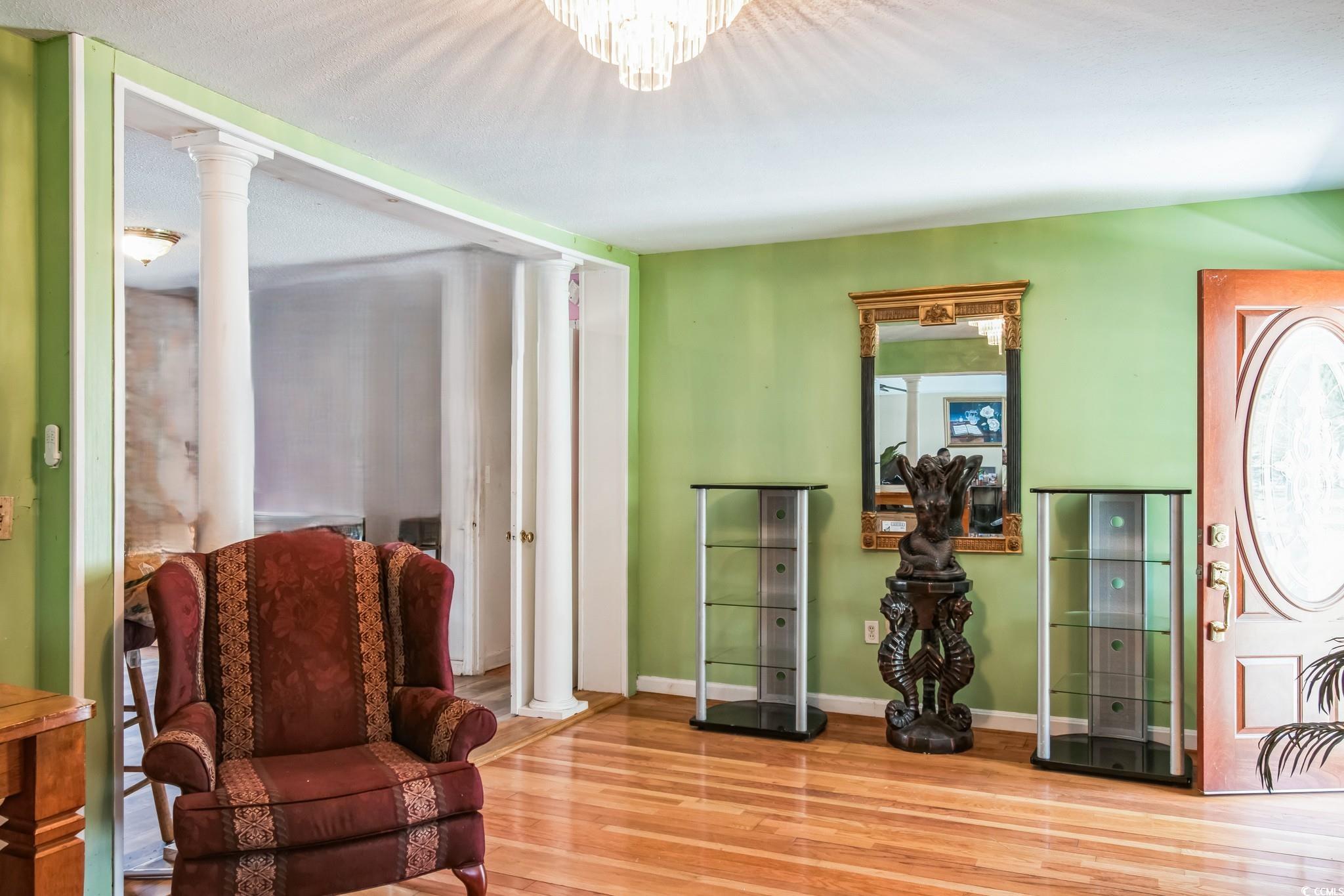 54 Juniper Place Georgetown, SC 29440 - Photo 5 of 11 Living area with ornate columns and wood finished floors