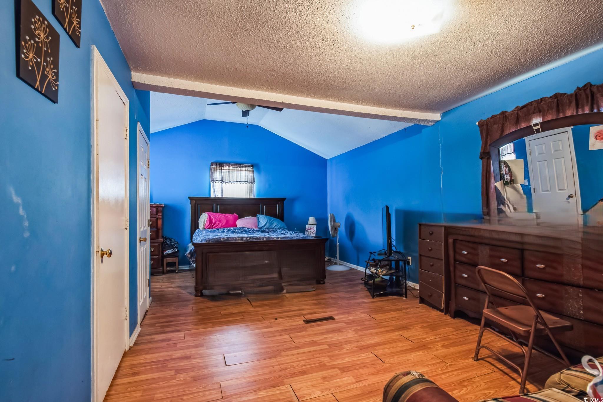 54 Juniper Place Georgetown, SC 29440 - Photo 7 of 11 Bedroom featuring hardwood / wood-style floors and a textured ceiling