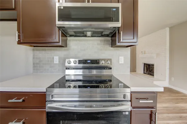a stove top oven sitting inside of a kitchen