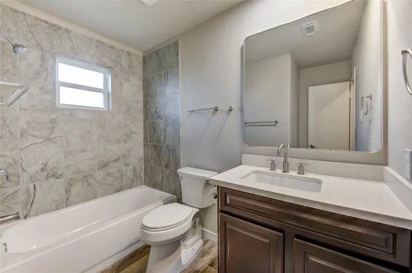 a bathroom with a sink a toilet and bathtub