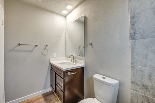 a bathroom with a toilet sink and mirror