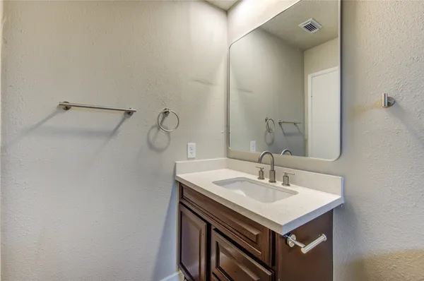 a bathroom with a sink vanity and a mirror
