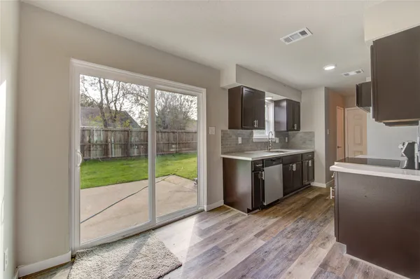 a kitchen with kitchen island granite countertop a stove top oven microwave and refrigerator