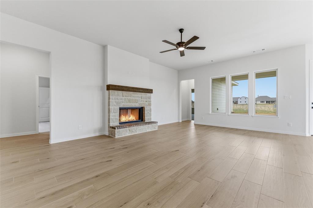 114 Brandywine Trail Rhome, TX 76078 - Photo 14 of 27 a view of an empty room with a fireplace and a window