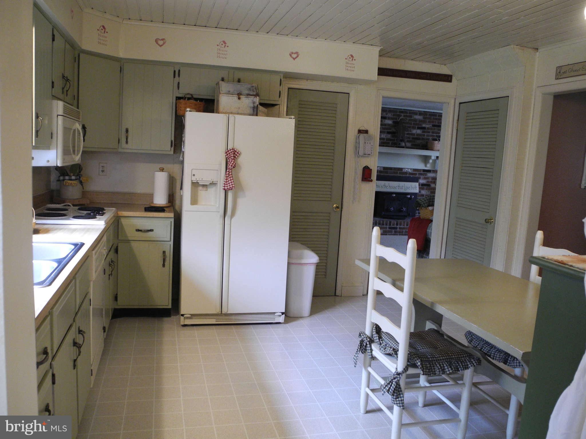 1223 Peachtree Road Fallston, MD 21047 - Photo 3 of 22 a kitchen with a refrigerator a stove and a dining table