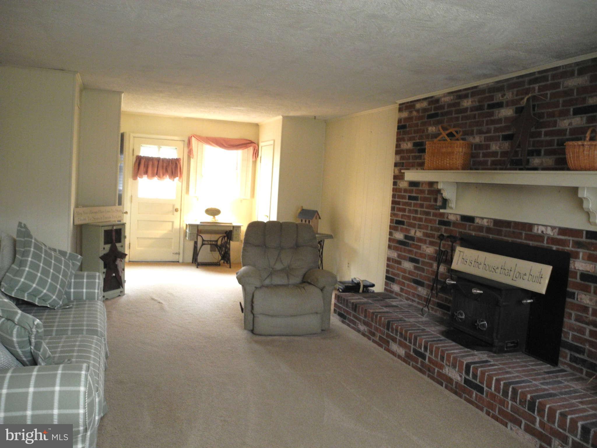 1223 Peachtree Road Fallston, MD 21047 - Photo 8 of 22 a living room with furniture and a fireplace
