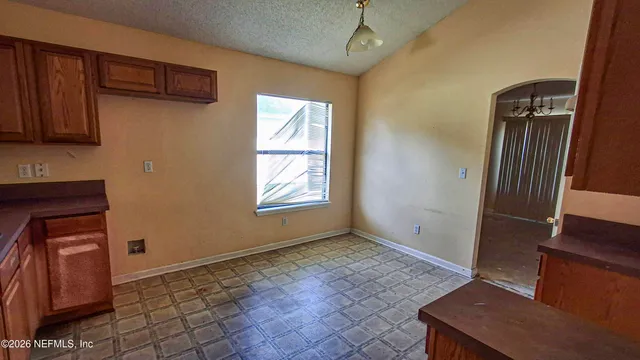a view of room with window and wooden floor