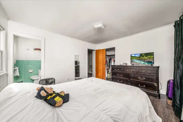 a bedroom with a bed and a dresser