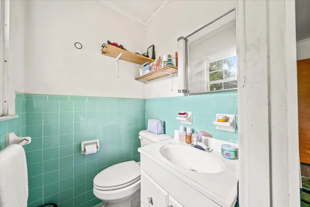 a bathroom with a sink a toilet and a shower curtain