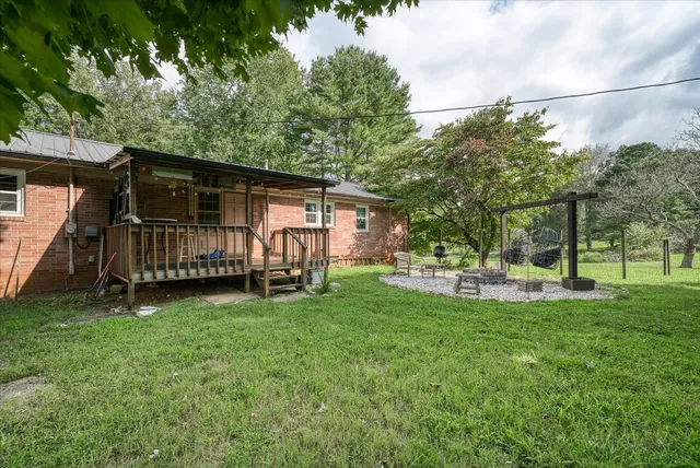 a view of backyard with a garden and deck