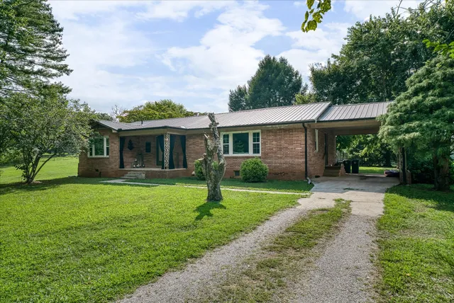 a front view of a house with a garden