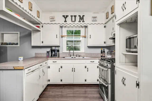 a kitchen with stainless steel appliances granite countertop a stove and a sink
