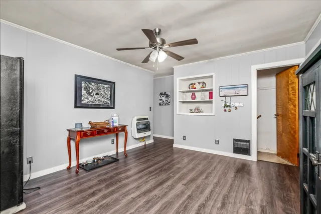 a view of a workspace with furniture and wooden floor