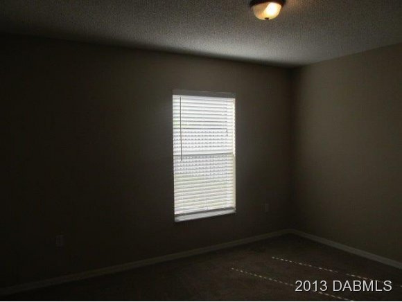 304 Mariners Gate Drive Edgewater, FL 32141 - Photo 12 of 16 a view of an empty room with a window