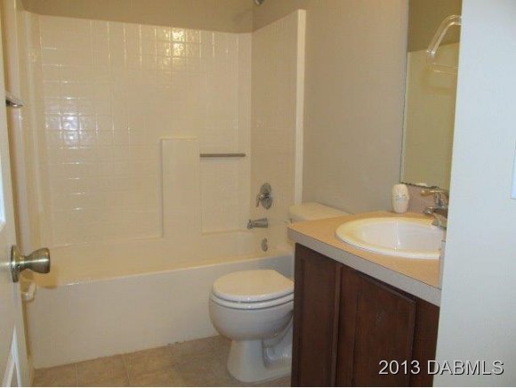 304 Mariners Gate Drive Edgewater, FL 32141 - Photo 13 of 16 a bathroom with a sink a toilet and shower