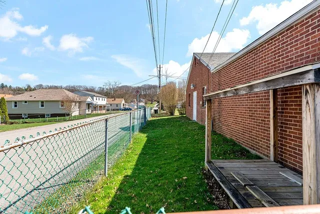a view of a balcony with yard