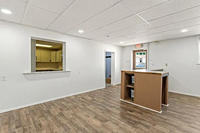 a view of a room with wooden floor and window