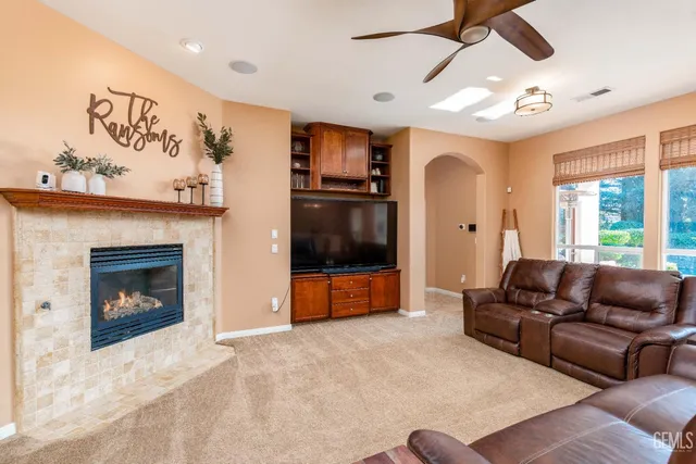 a living room with furniture a fireplace and a flat screen tv