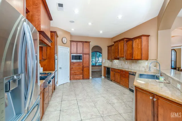 a dining room with stainless steel appliances kitchen island granite countertop a table and chairs
