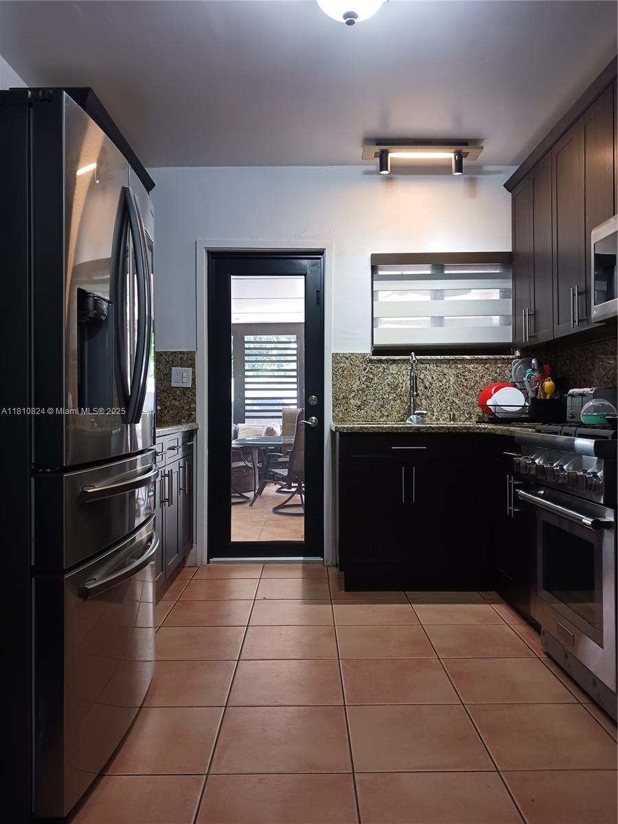 3429 Southwest 23rd Terrace Miami, FL 33145 - Photo 11 of 32 a kitchen with a refrigerator and a stove top oven
