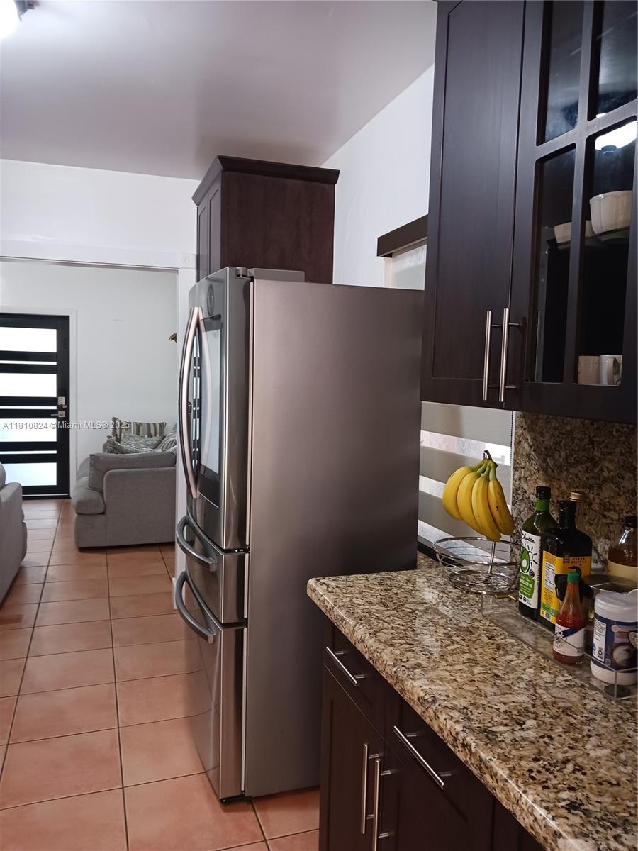 3429 Southwest 23rd Terrace Miami, FL 33145 - Photo 12 of 32 a kitchen with stainless steel appliances granite countertop a refrigerator and a sink