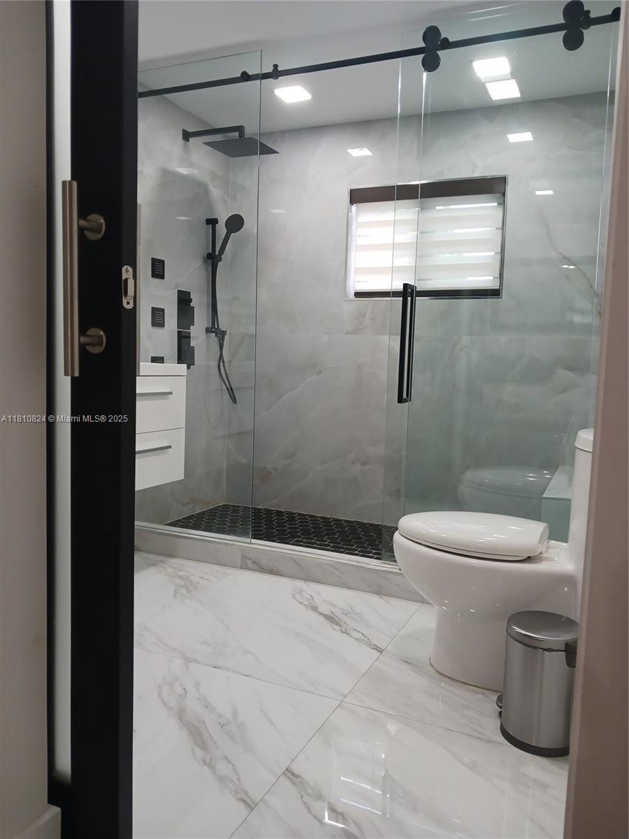 3429 Southwest 23rd Terrace Miami, FL 33145 - Photo 18 of 32 a bathroom with a shower a toilet and a shower